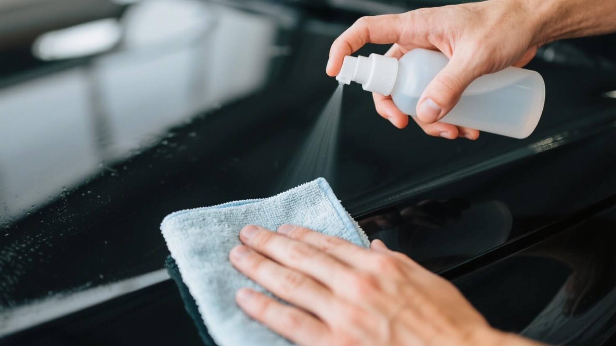 dreamina-2025-07-26-6592-Hands cleaning a car hood with a spray b...